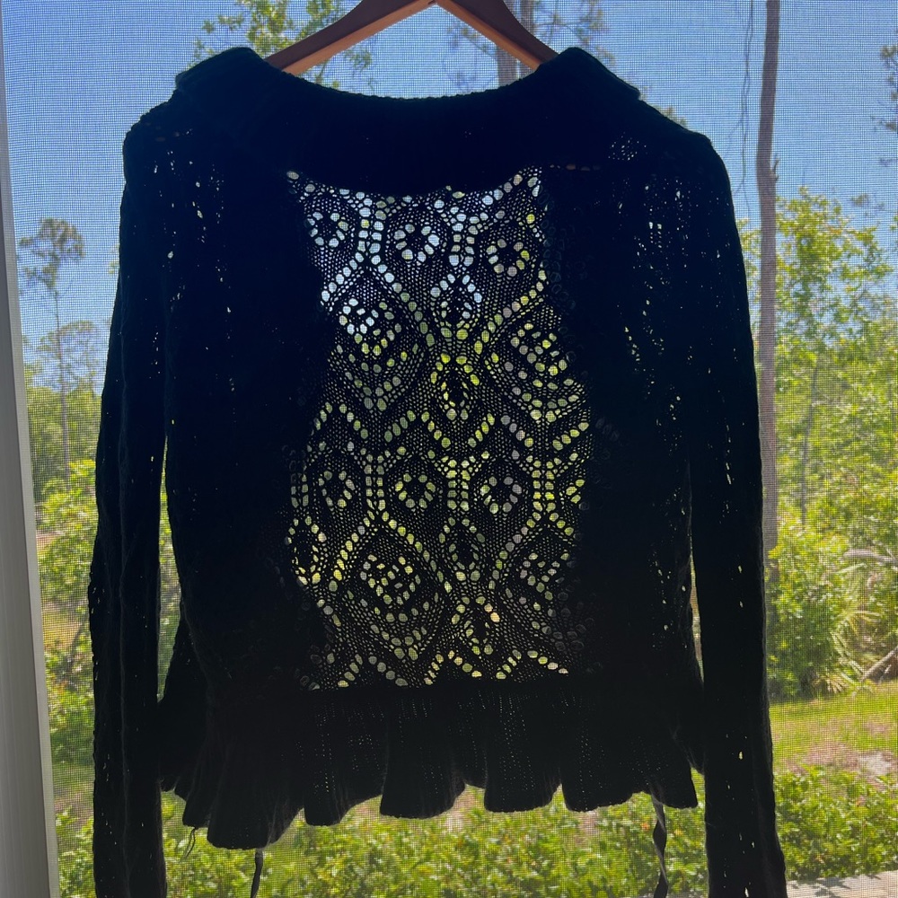 Cute black ruffled vintage cardigan 
Small rip is covered up on person w/ruffles